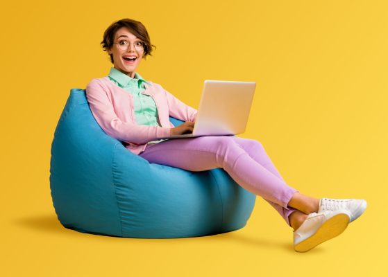 Happy lady sat on beanbag using Giganet's full fibre broadband service