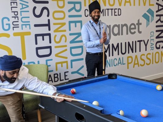 Giganet staff playing pool in the full fibre office