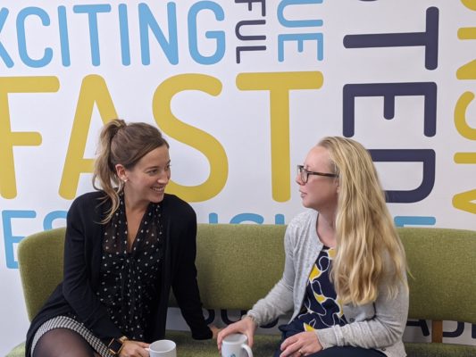 Giganet office managers sat on sofa creating a progressive environment