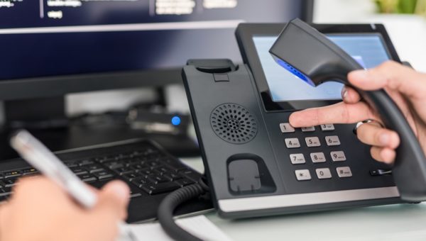 Business owner using Giganet hosted telephony handset