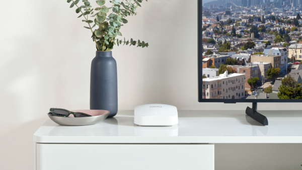 White Amazon Eero Pro router on white cabinet