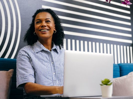 Woman browsing internet on laptop powered by Giganet connectivity