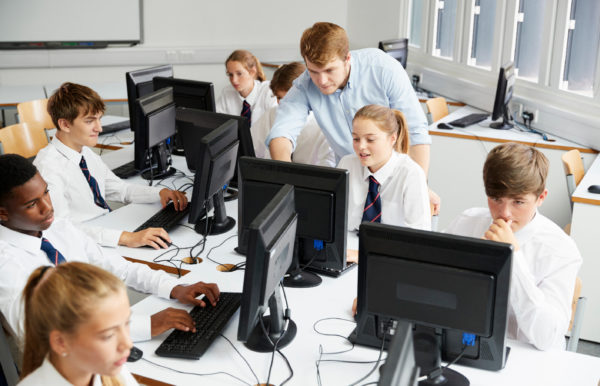 Teacher with students in IT classroom